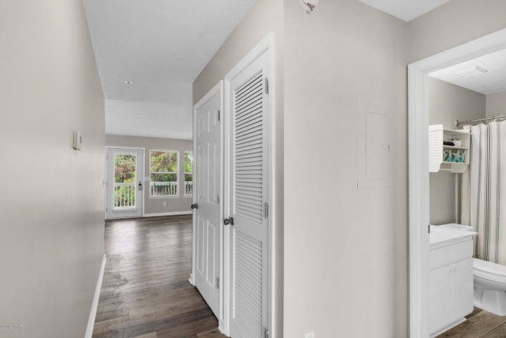 17690 Front Beach Road, Unit D207 Panama City Beach, FL 32413 - Photo 26 of 28 a view of hallway with bathroom and wooden floor