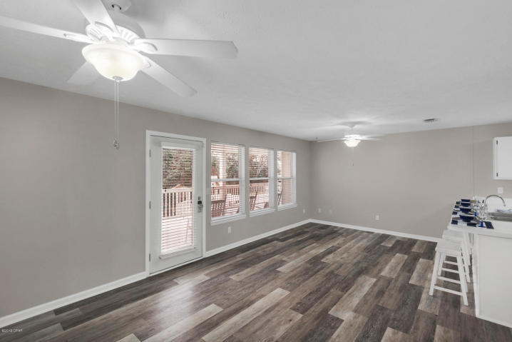 17690 Front Beach Road, Unit D207 Panama City Beach, FL 32413 - Photo 6 of 28 a view of an empty room with a window and wooden floor