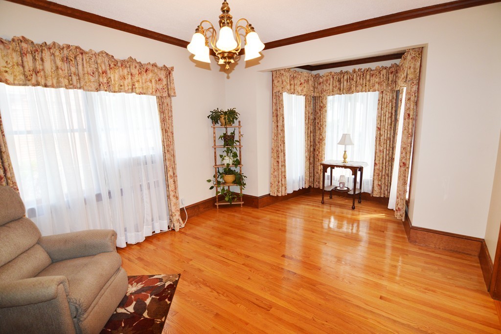 73 Castle Street Springfield, MA 01118 - Photo 8 of 30 a view of an empty room with a window and wooden floor