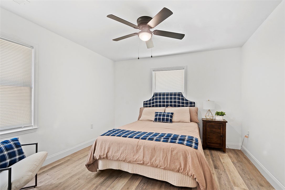 701 Quarry Street Anderson, SC 29624 - Photo 15 of 16 A well-lit sleeping quarter features warm-toned flooring and a convenient ceiling fan for comfort.