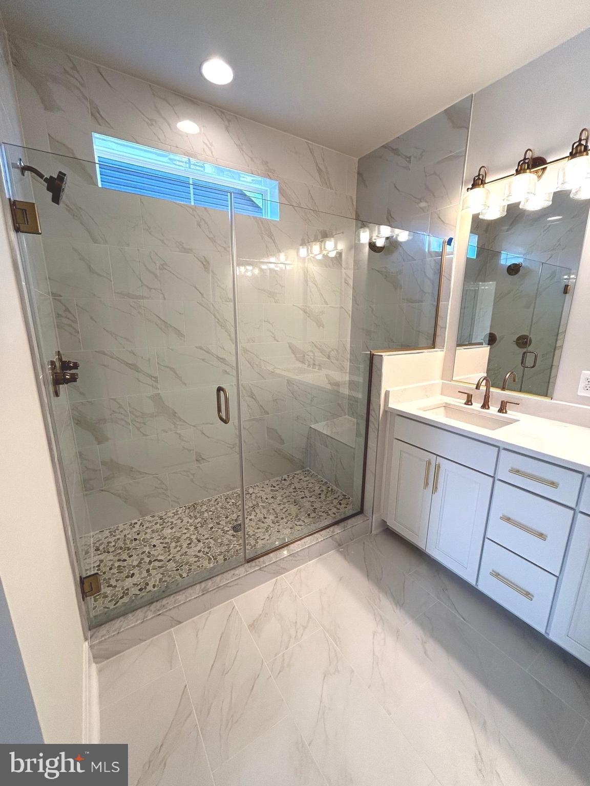 30078 Chase Oaks Drive Lewes, DE 19958 - Photo 11 of 17 a bathroom with a sink shower and a mirror