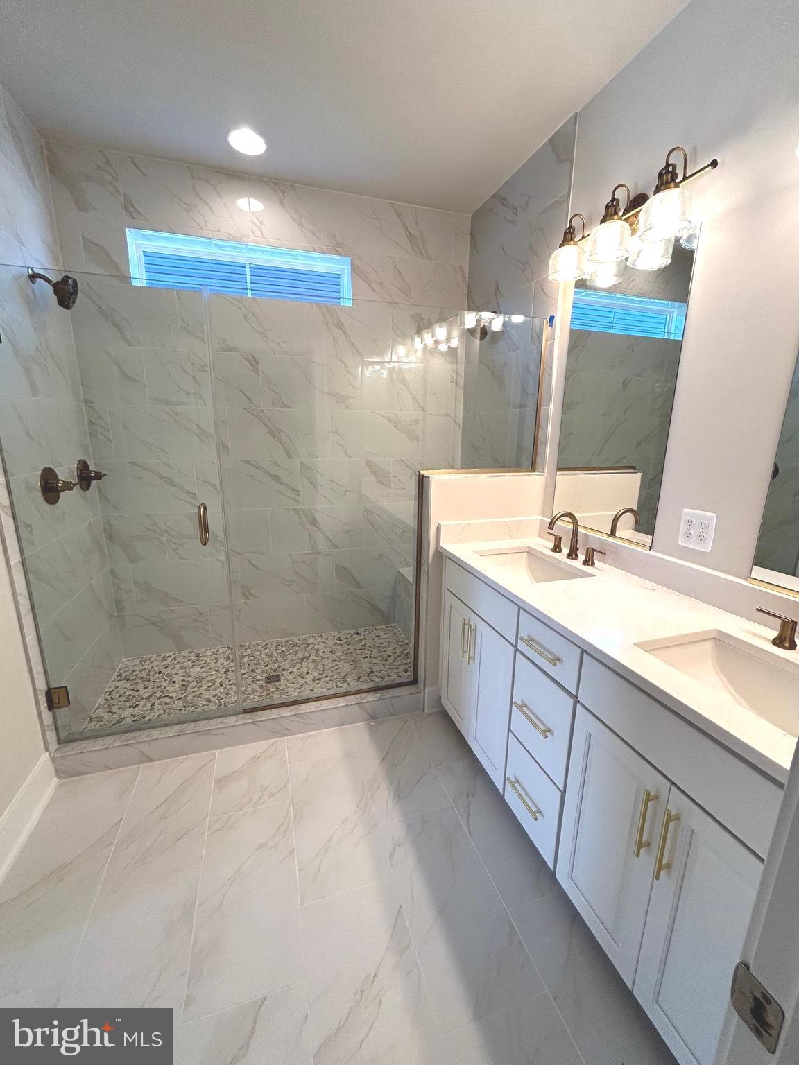 30078 Chase Oaks Drive Lewes, DE 19958 - Photo 12 of 17 a bathroom with a double vanity sink mirror and shower