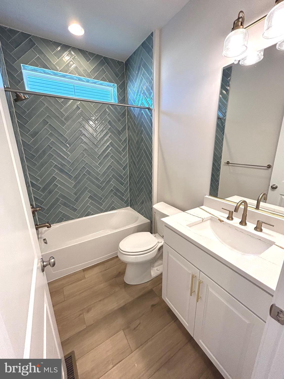 30078 Chase Oaks Drive Lewes, DE 19958 - Photo 13 of 17 a bathroom with a sink a toilet and shower