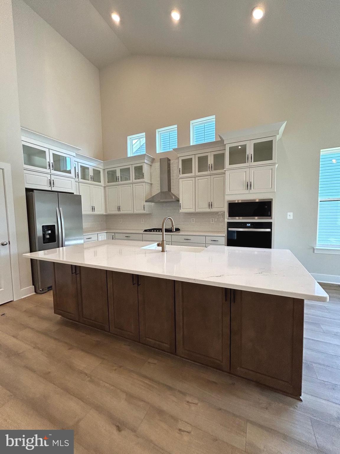 30078 Chase Oaks Drive Lewes, DE 19958 - Photo 2 of 17 a kitchen with stainless steel appliances a sink and cabinets