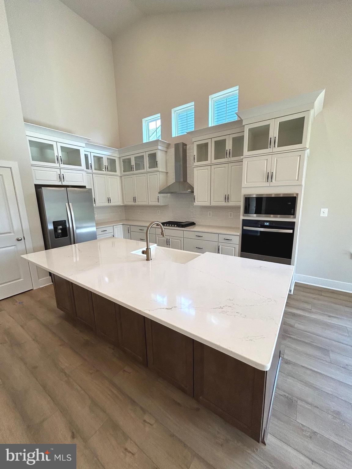30078 Chase Oaks Drive Lewes, DE 19958 - Photo 3 of 17 a kitchen with stainless steel appliances a sink and wooden floor