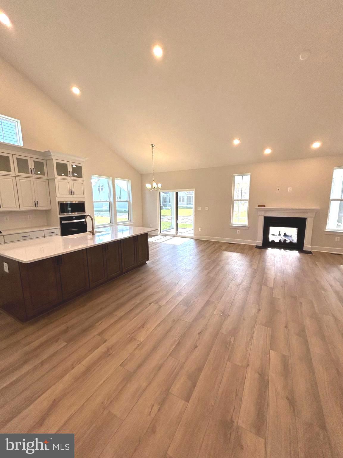 30078 Chase Oaks Drive Lewes, DE 19958 - Photo 4 of 17 a large kitchen with stainless steel appliances granite countertop a large counter top and a stove