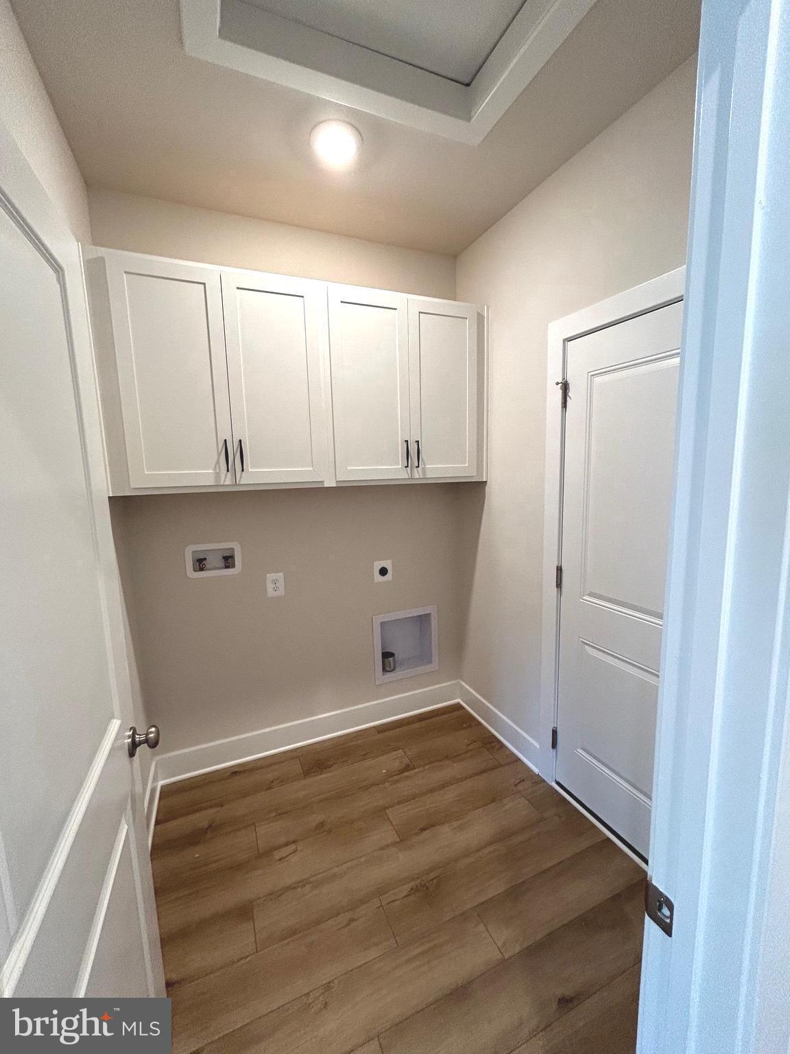 30078 Chase Oaks Drive Lewes, DE 19958 - Photo 10 of 17 a view of a kitchen with white cabinets and wooden floor