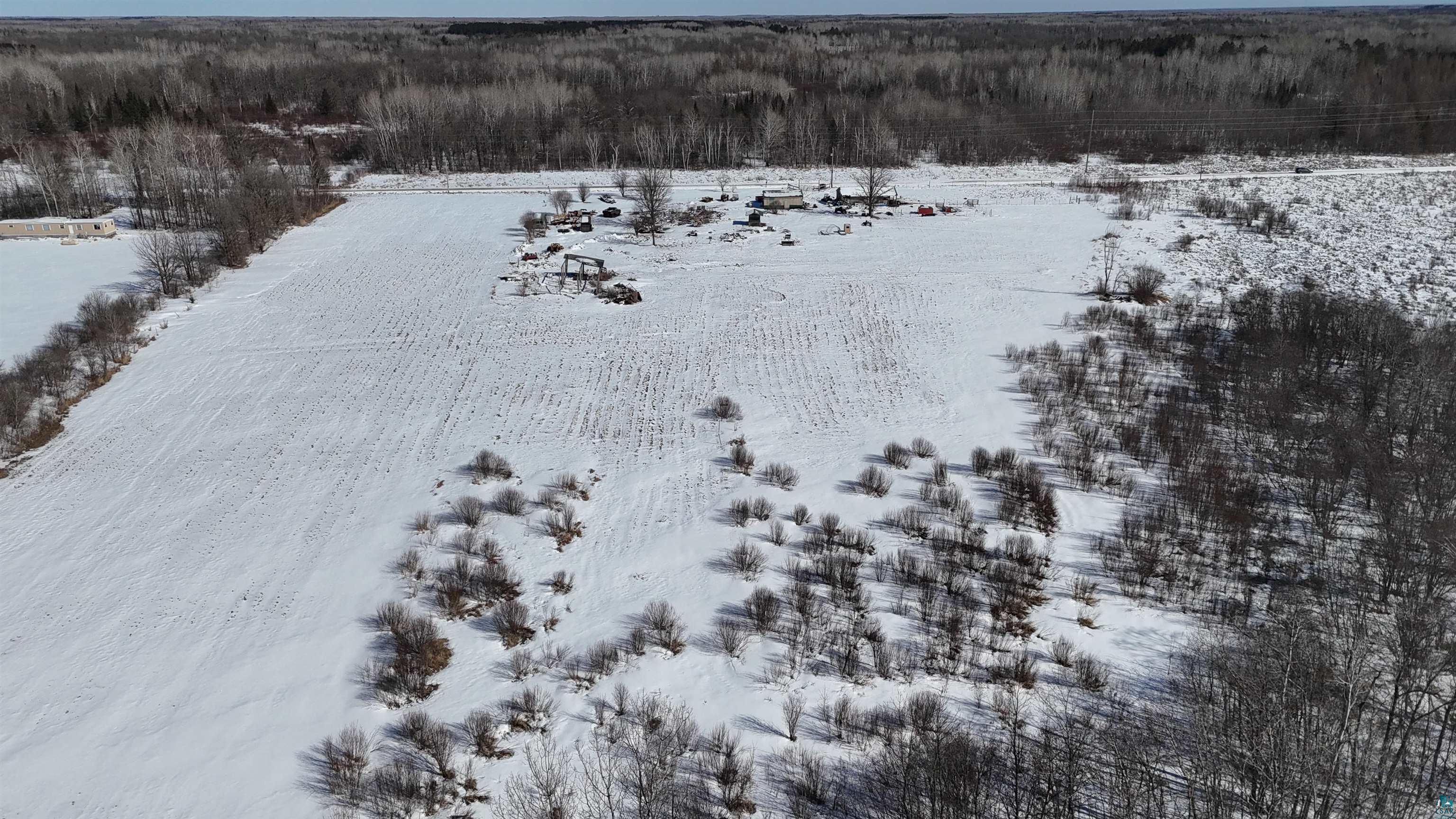 2865 Lund Road Kettle River, MN 55757 - Photo 18 of 21 Snowy aerial view featuring a view of trees