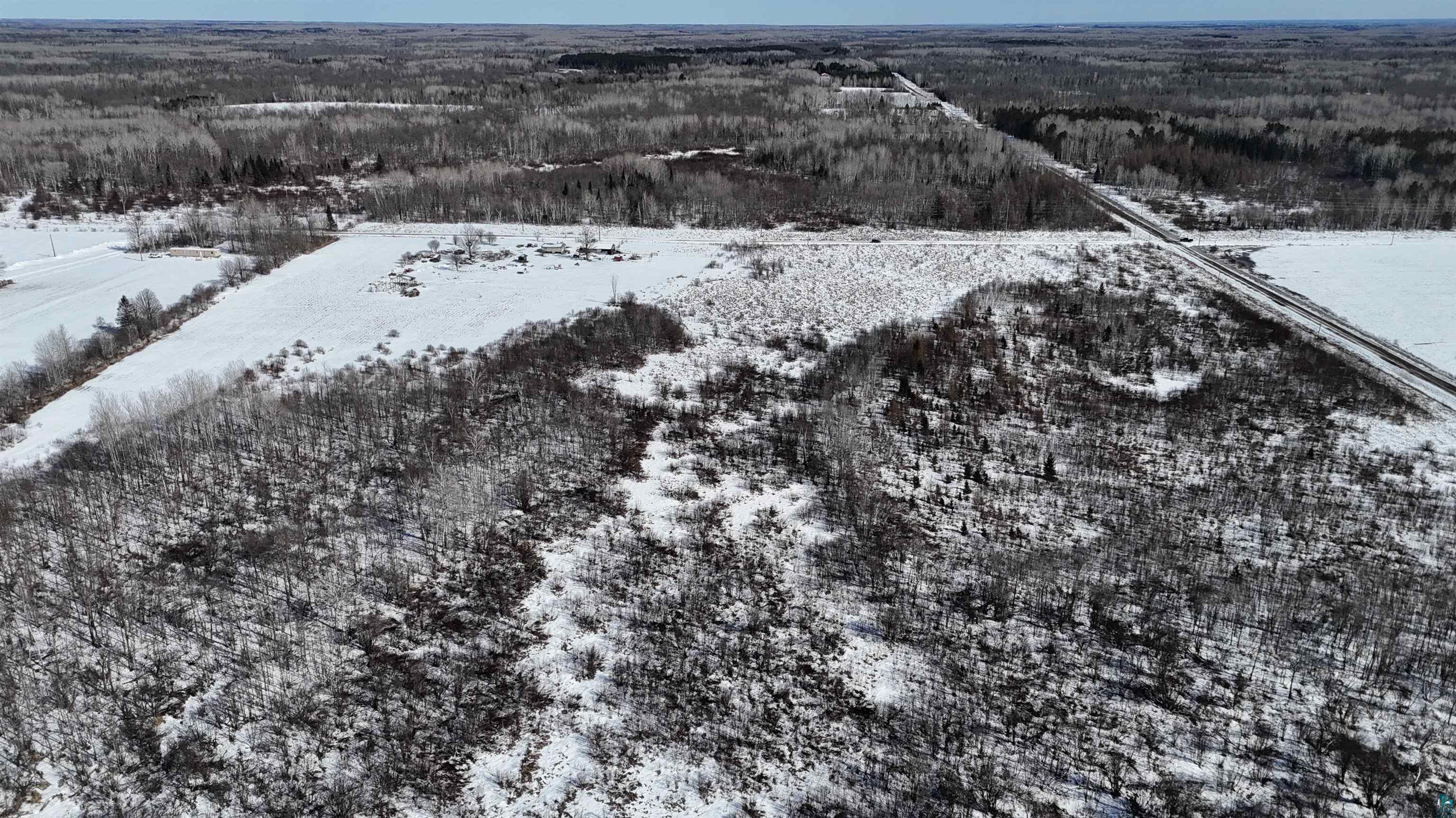 2865 Lund Road Kettle River, MN 55757 - Photo 9 of 21 Snowy aerial view featuring a wooded view