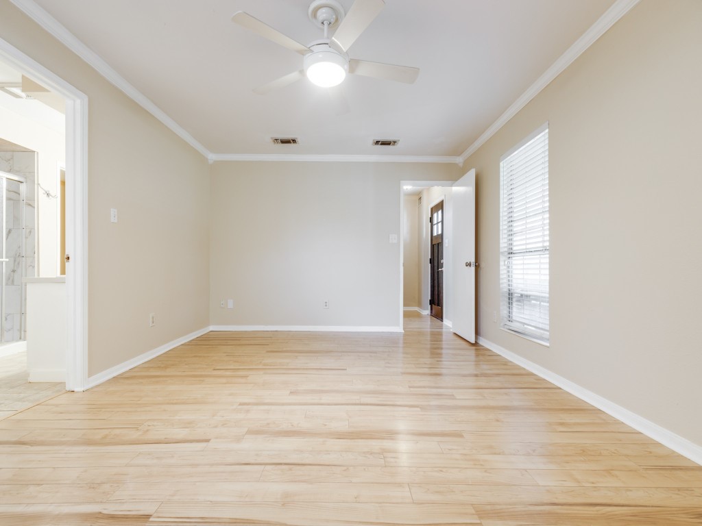 2403 Pecan Wood Lane Rosenberg, TX 77471 - Photo 13 of 25 a view of an empty room with wooden floor and a window