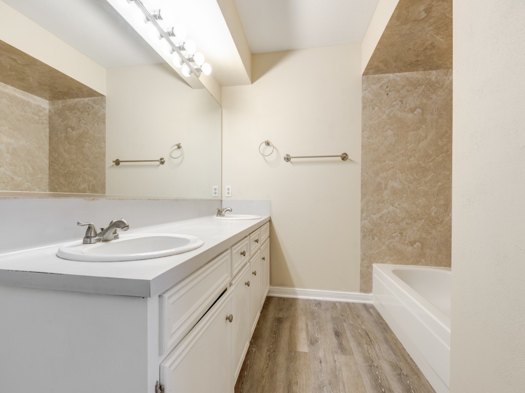 2403 Pecan Wood Lane Rosenberg, TX 77471 - Photo 17 of 25 a bathroom with a sink a mirror and a bathtub