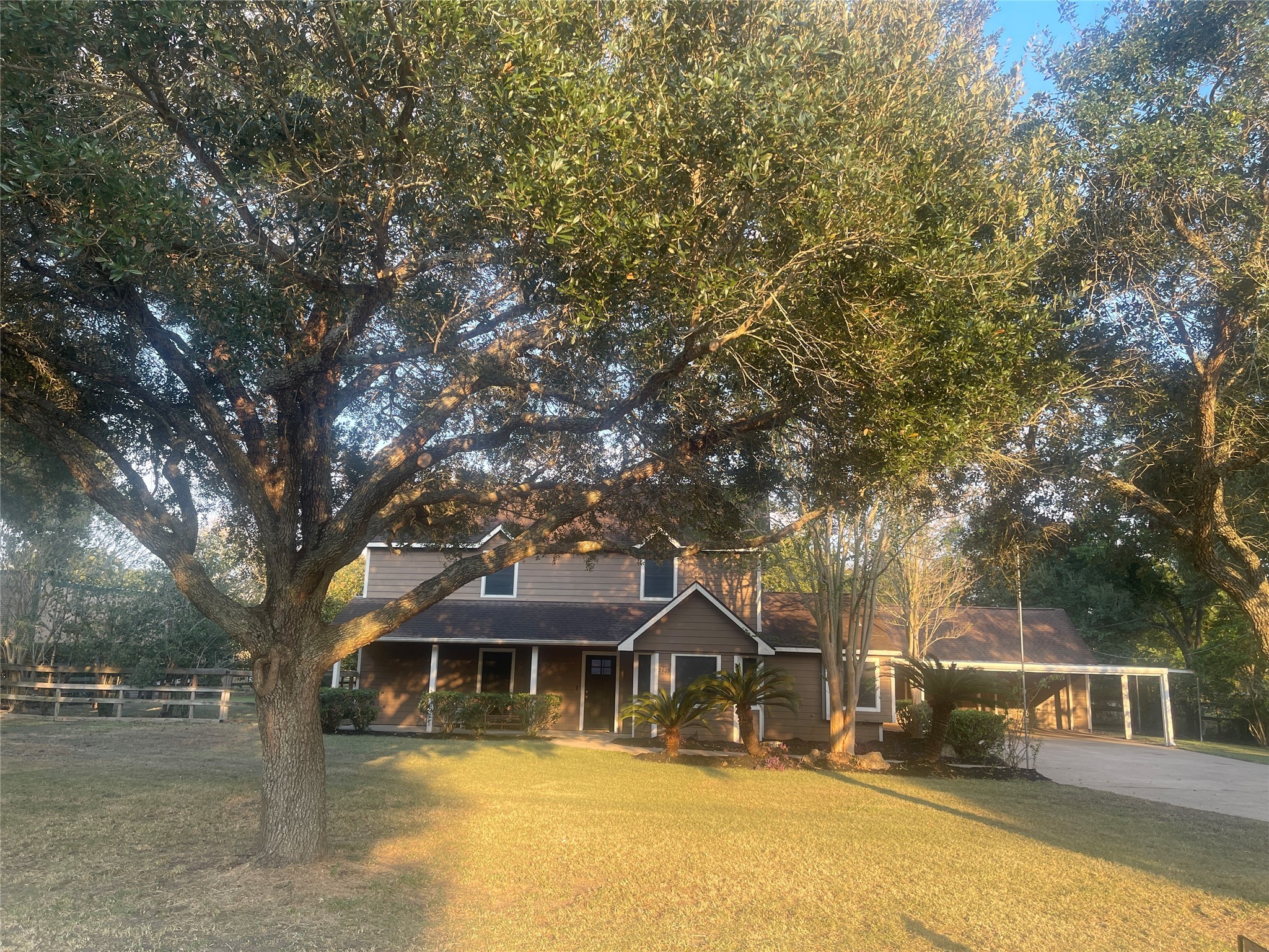 2403 Pecan Wood Lane Rosenberg, TX 77471 - Photo 5 of 25 a front view of a house with a yard and trees