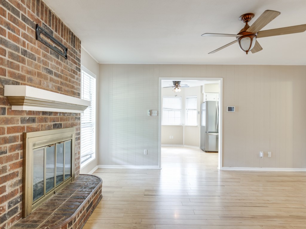 2403 Pecan Wood Lane Rosenberg, TX 77471 - Photo 8 of 25 a view of a livingroom with wooden floor and a fireplace