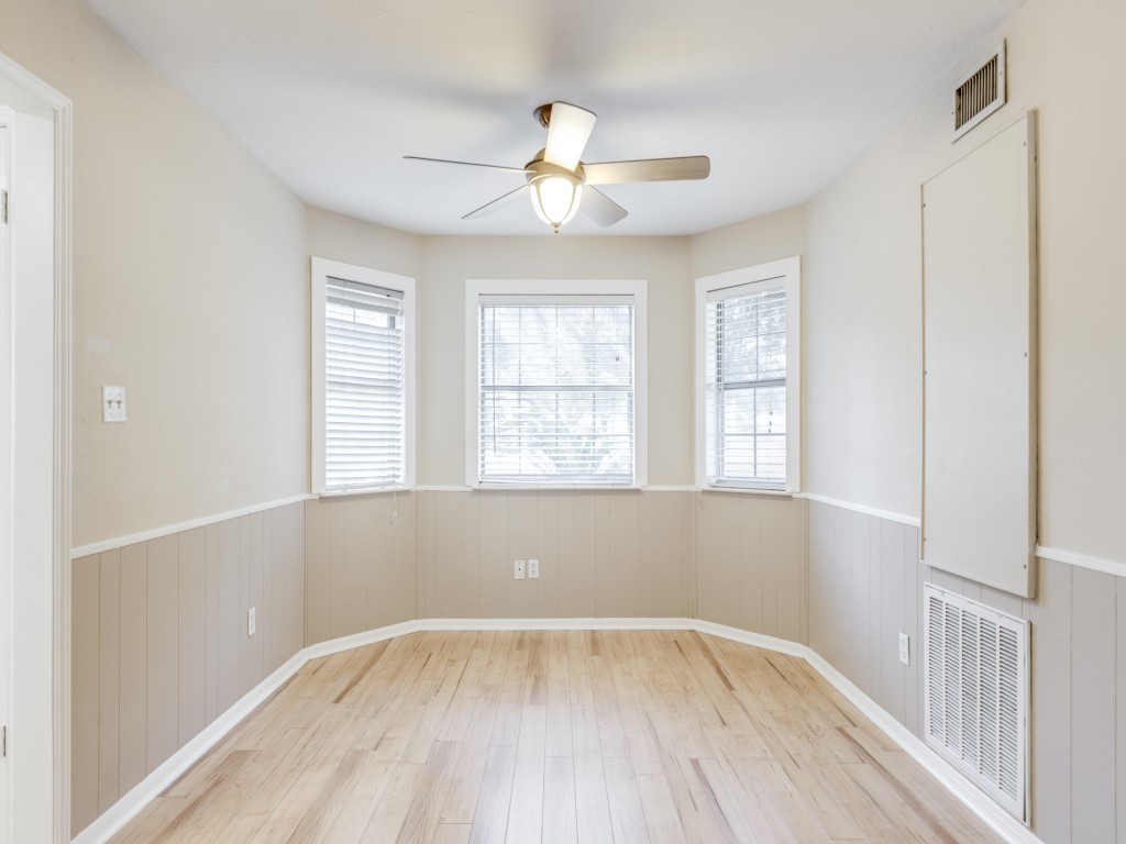 2403 Pecan Wood Lane Rosenberg, TX 77471 - Photo 9 of 25 a view of an empty room with wooden floor and a window