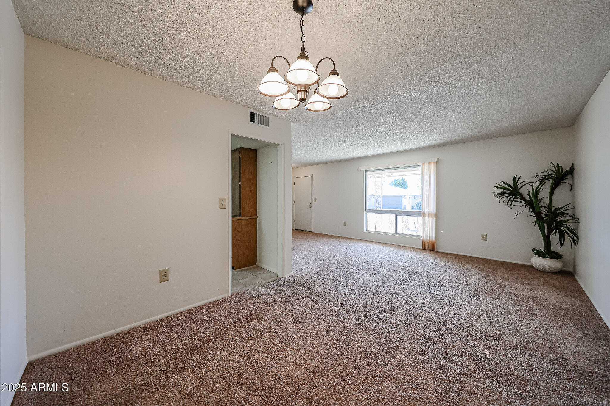 10326 West Pleasant Valley Road Sun City, AZ 85351 - Photo 10 of 25 a view of an empty room with window and wooden floor