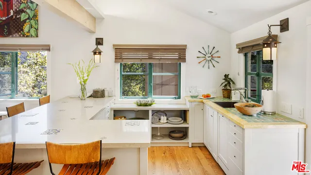 a kitchen with a stove a sink and a refrigerator