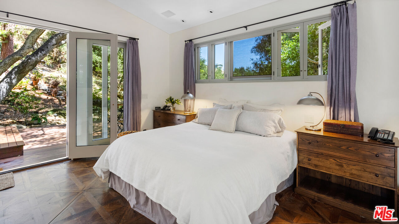635-637 Greenleaf Canyon Road Topanga, CA 90290 - Photo 26 of 52 a bedroom with a bed and wooden floor
