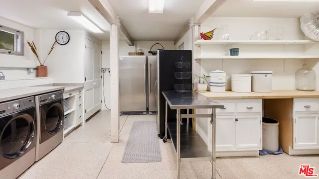a kitchen with cabinets and stainless steel appliances