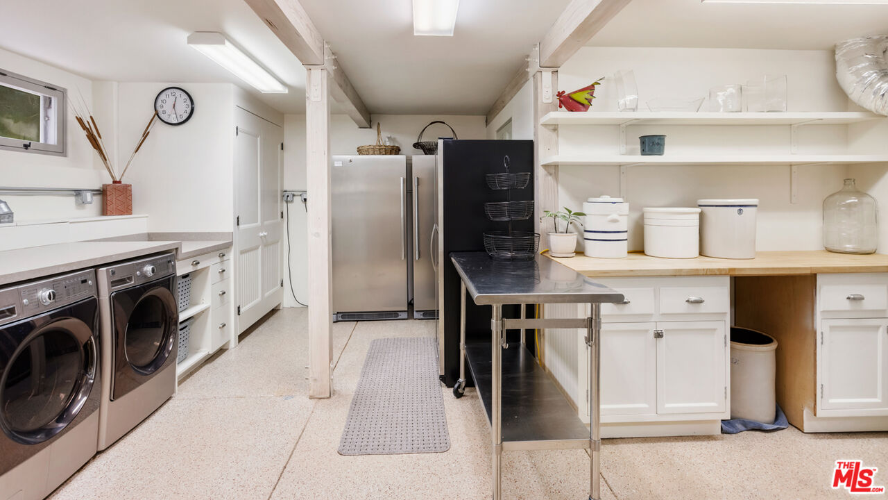 635-637 Greenleaf Canyon Road Topanga, CA 90290 - Photo 27 of 52 a kitchen with cabinets and stainless steel appliances