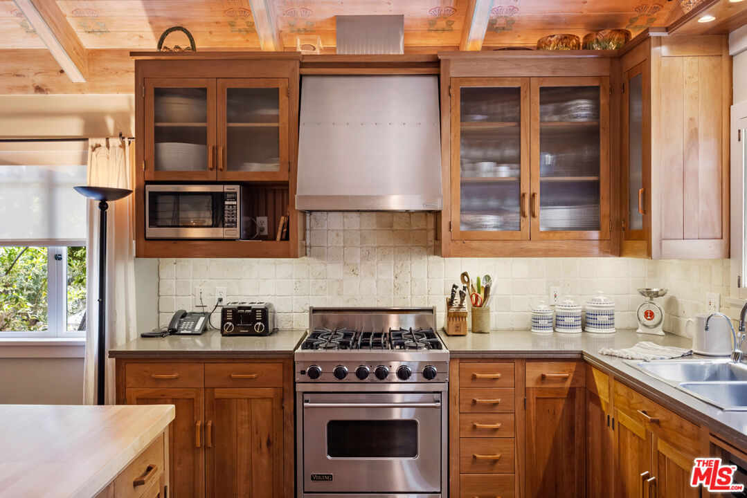 635-637 Greenleaf Canyon Road Topanga, CA 90290 - Photo 34 of 52 a kitchen with stainless steel appliances granite countertop a stove and a sink