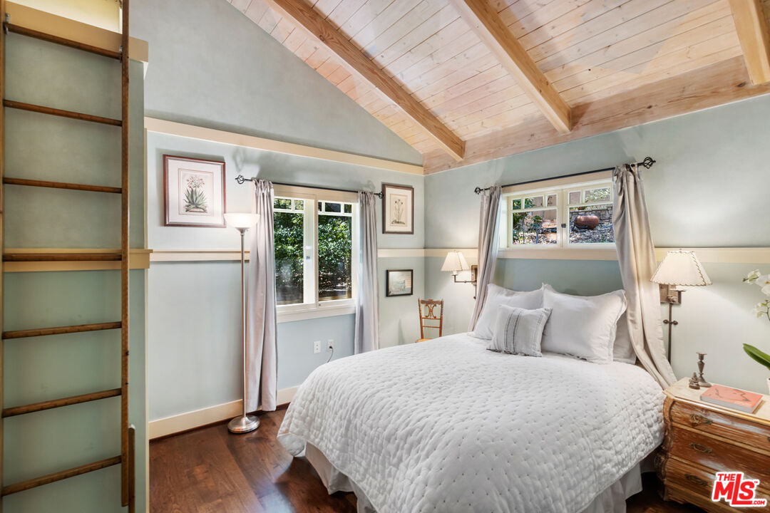 635-637 Greenleaf Canyon Road Topanga, CA 90290 - Photo 38 of 52 a bedroom with a large bed and a chandelier