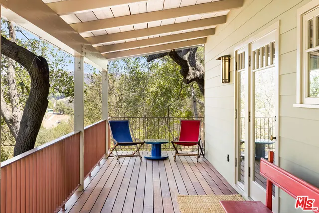 a view of a balcony with furniture and wooden floor