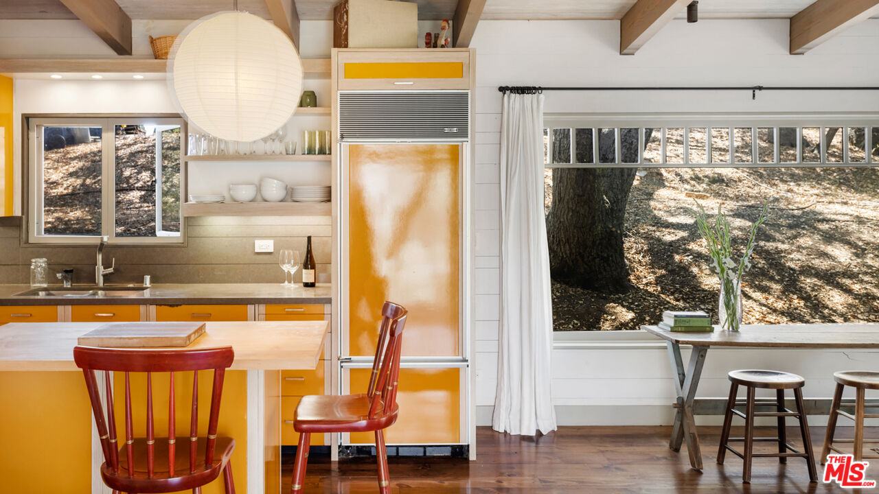 635-637 Greenleaf Canyon Road Topanga, CA 90290 - Photo 42 of 52 a view of a swimming pool with a table and chairs