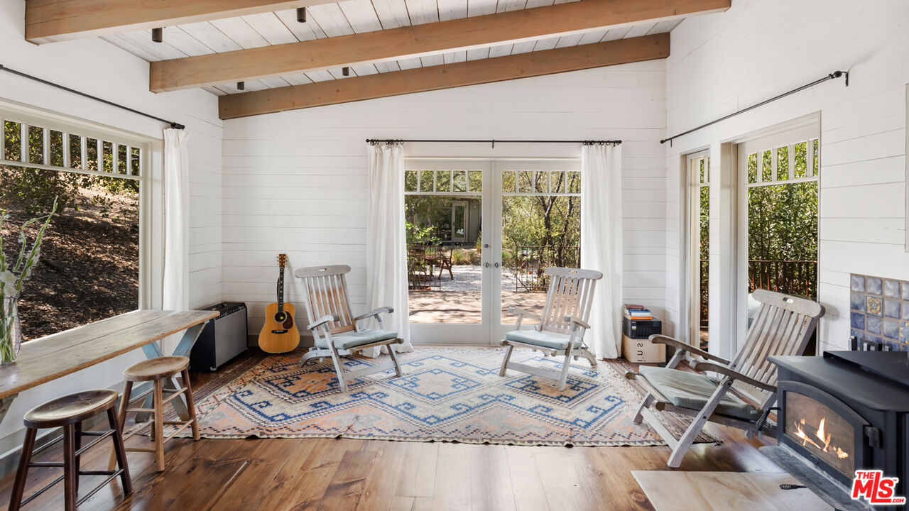 635-637 Greenleaf Canyon Road Topanga, CA 90290 - Photo 43 of 52 a living room with furniture a large window and wooden floor