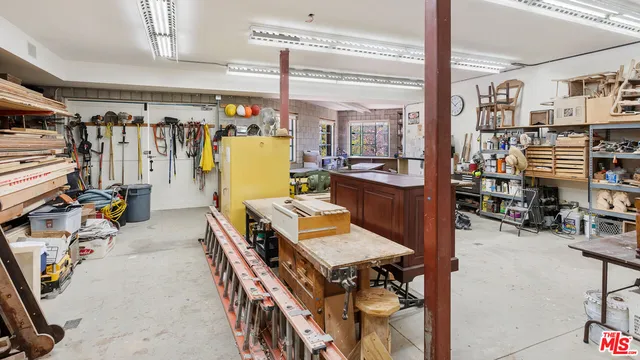 a room with lots of wooden furniture and a chandelier
