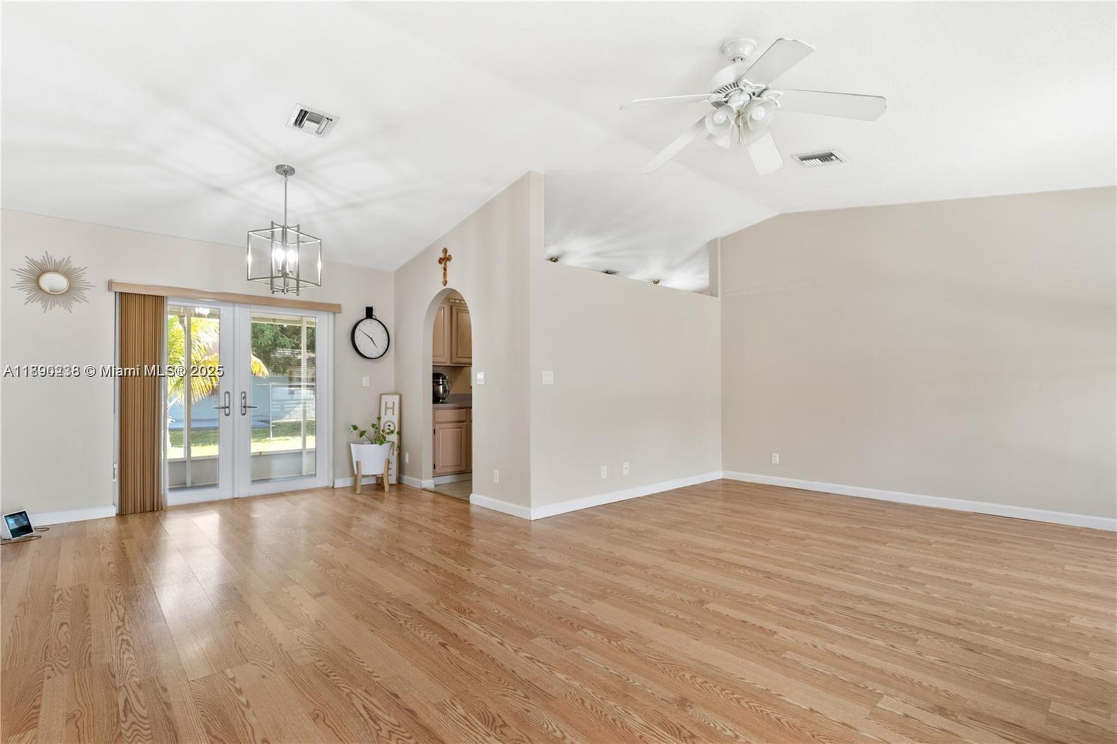 13752 Southwest 285th Street Homestead, FL 33033 - Photo 11 of 25 a view of a room with wooden floor chandelier and entryway