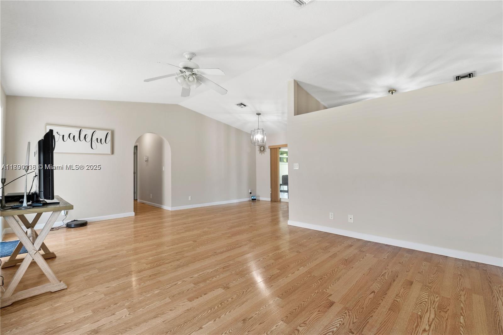 13752 Southwest 285th Street Homestead, FL 33033 - Photo 14 of 25 a view of a livingroom with wooden floor and a ceiling fan