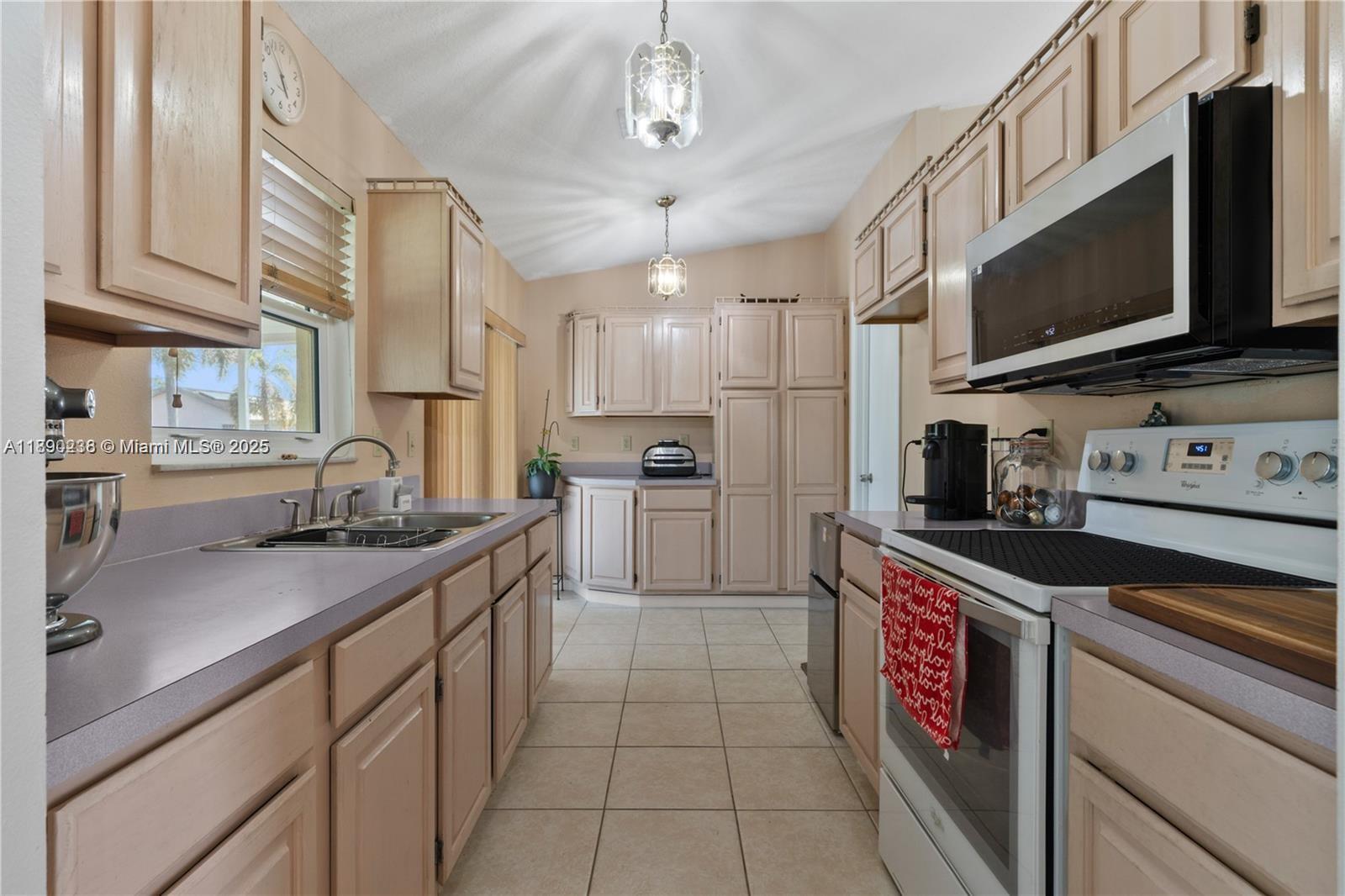 13752 Southwest 285th Street Homestead, FL 33033 - Photo 17 of 25 a kitchen with stainless steel appliances granite countertop a sink and a stove