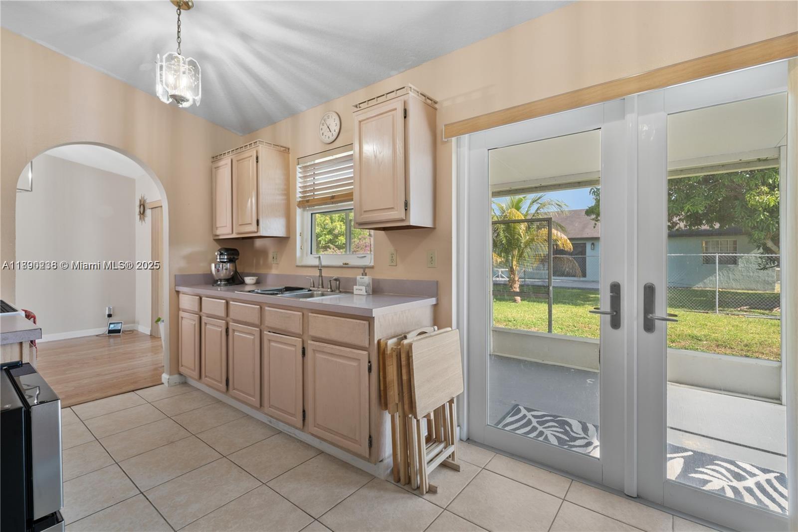 13752 Southwest 285th Street Homestead, FL 33033 - Photo 20 of 25 a kitchen with kitchen island granite countertop a stove a sink and a refrigerator