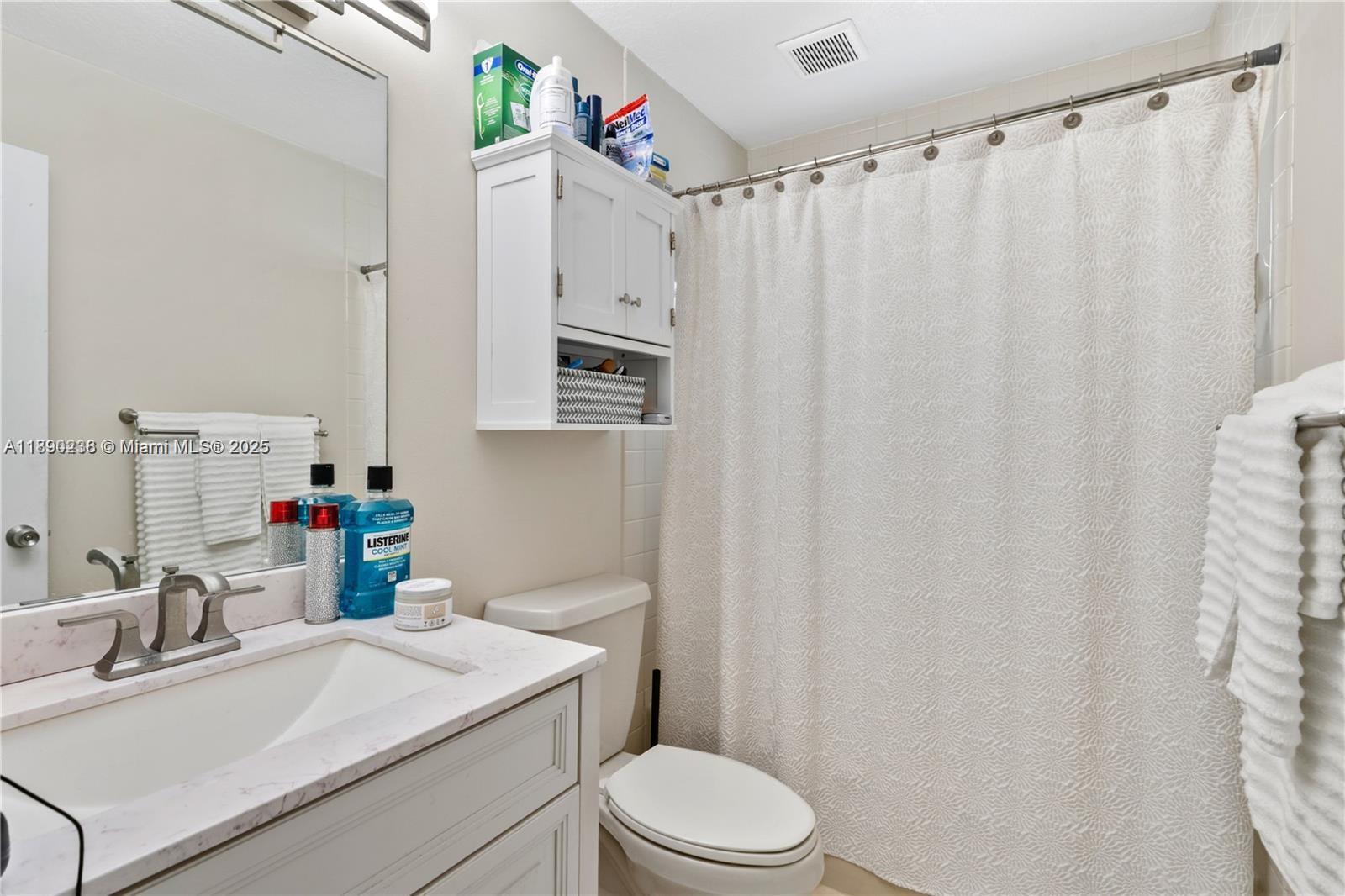 13752 Southwest 285th Street Homestead, FL 33033 - Photo 7 of 25 a bathroom with a sink a toilet and shower curtain