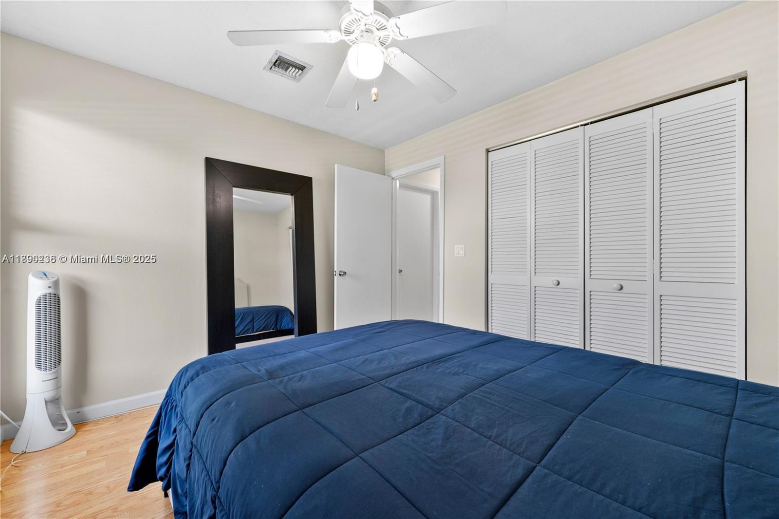 13752 Southwest 285th Street Homestead, FL 33033 - Photo 9 of 25 a bedroom with a large bed and a chandelier