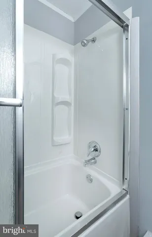 a white bath tub sitting next to a window