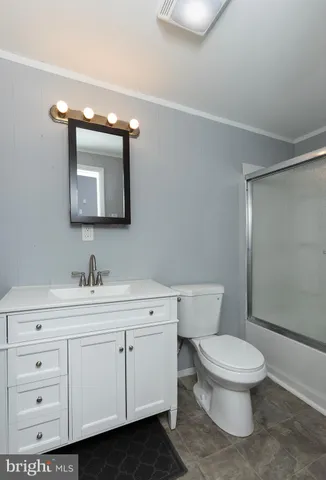 a white toilet sitting next to a bathroom sink