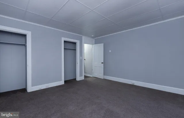 a view of a livingroom with a ceiling fan and window