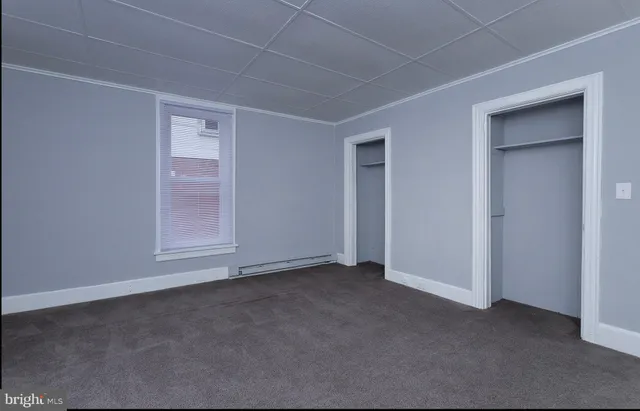 an empty room with windows and entrance