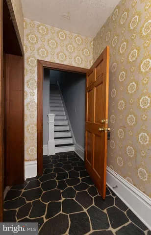 a bathroom with a glass door shower and a sink