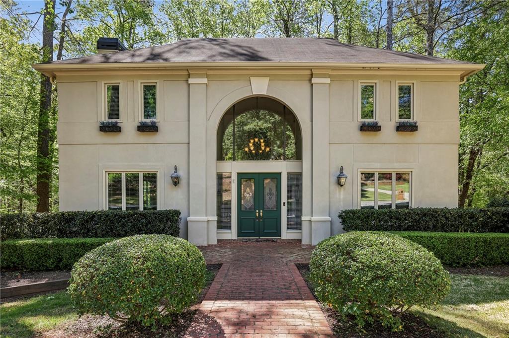 a view of a house with brick walls and a yard