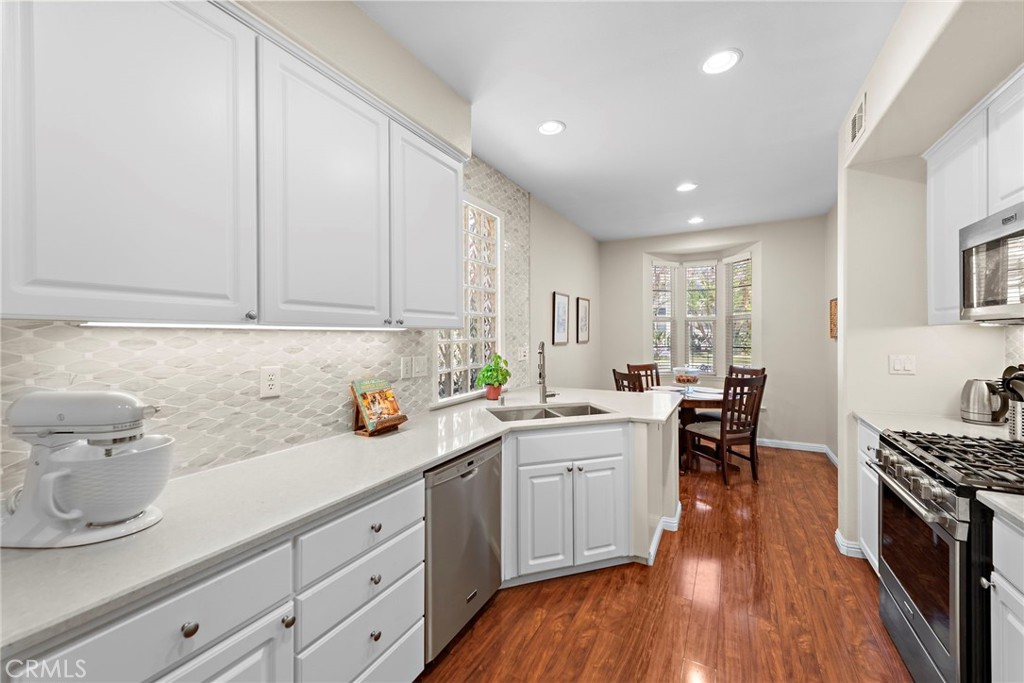81 Mercantile Way Ladera Ranch, CA 92694 - Photo 12 of 51 a kitchen with a sink and wooden floor