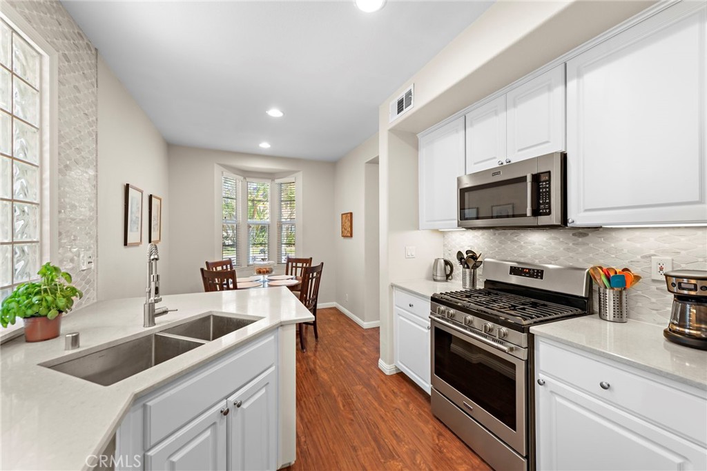 81 Mercantile Way Ladera Ranch, CA 92694 - Photo 13 of 51 a kitchen with sink a microwave and cabinets