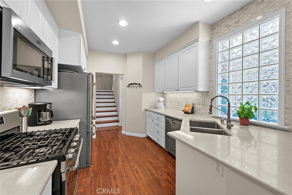 81 Mercantile Way Ladera Ranch, CA 92694 - Photo 15 of 51 a kitchen with stainless steel appliances granite countertop a sink stove and refrigerator