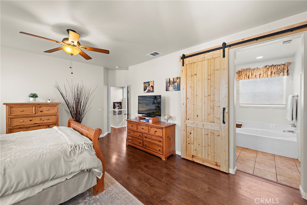 81 Mercantile Way Ladera Ranch, CA 92694 - Photo 18 of 51 a bedroom with a bed and a chandelier