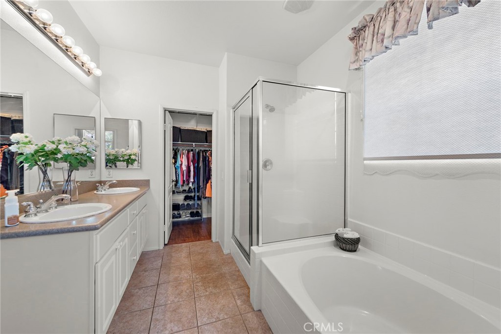 81 Mercantile Way Ladera Ranch, CA 92694 - Photo 19 of 51 a bathroom with a granite countertop sink a large mirror and a bathtub