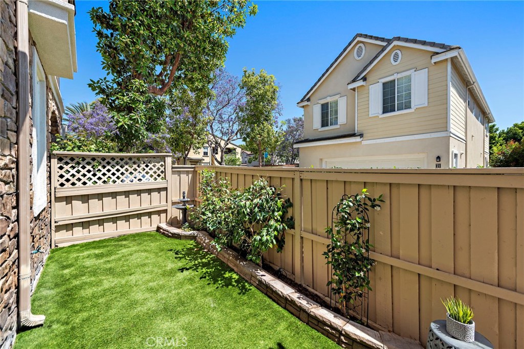 81 Mercantile Way Ladera Ranch, CA 92694 - Photo 29 of 51 a view of a house with a wooden fence