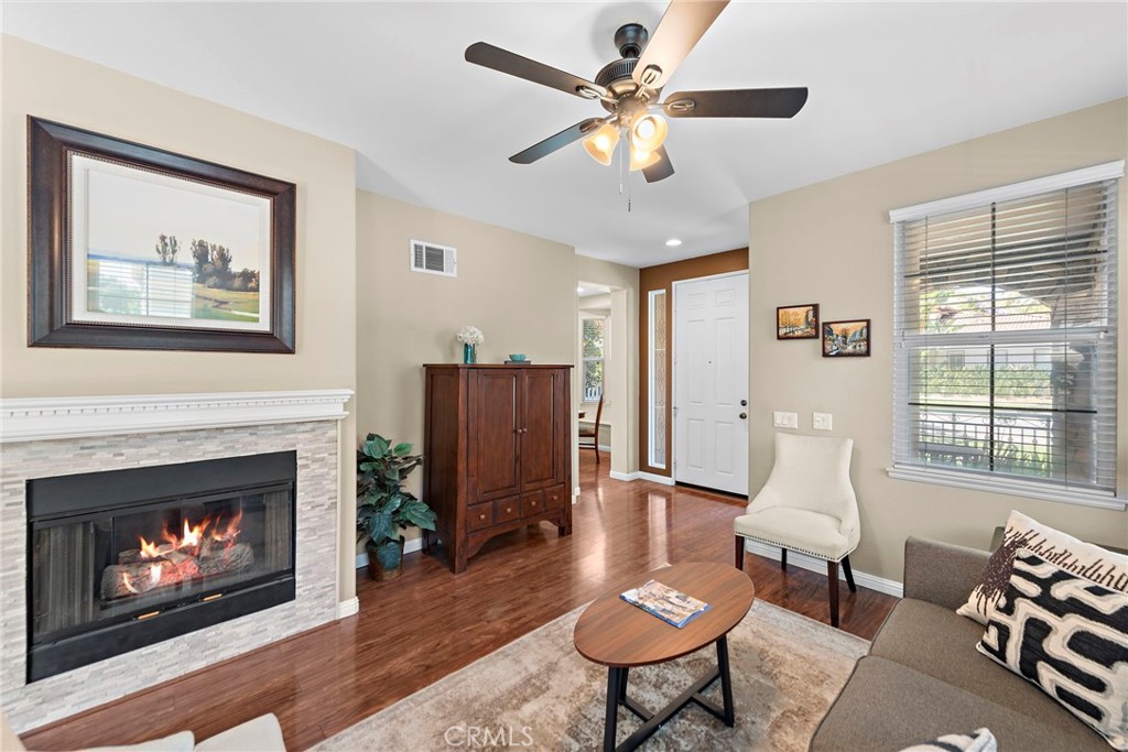 81 Mercantile Way Ladera Ranch, CA 92694 - Photo 9 of 51 a living room with furniture a fireplace and a large window