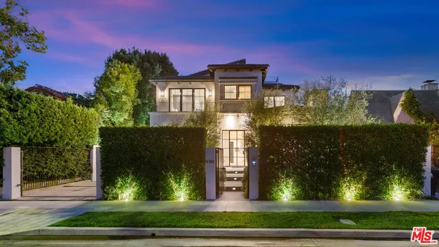 a front view of a residential apartment building with a yard