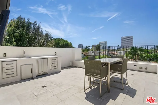 a living room with furniture and floor to ceiling windows